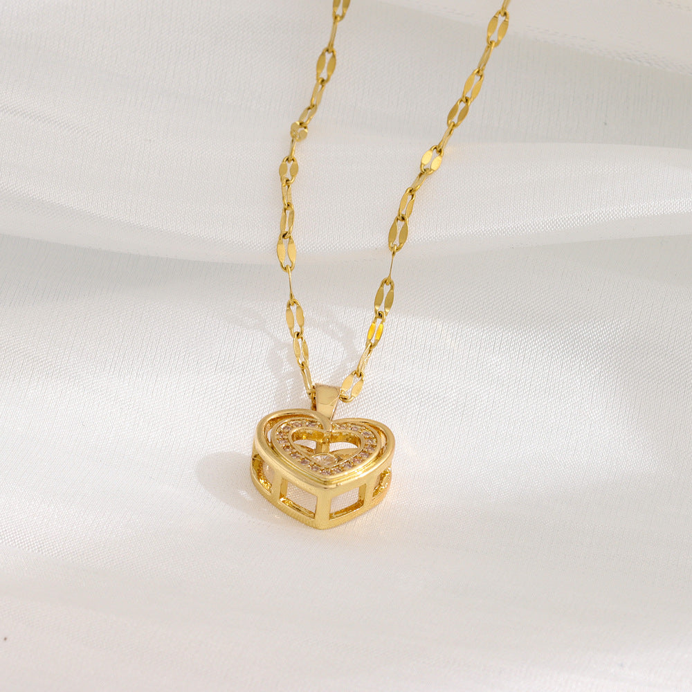Close-up of golden hollow heart pendant with sparkling crystals